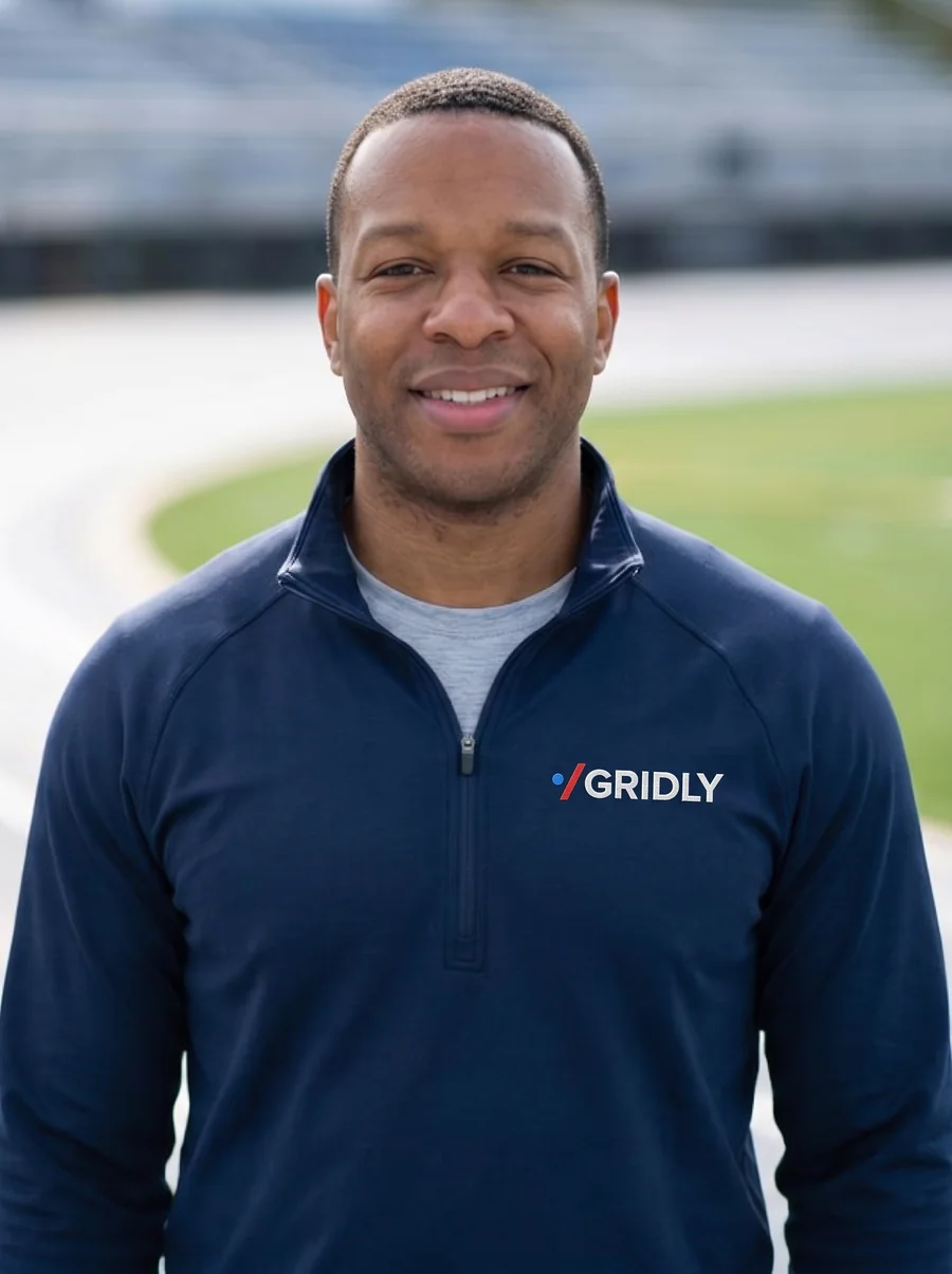 Keith Godding, the founder of Gridly, wearing a Gridly pullover at a stadium